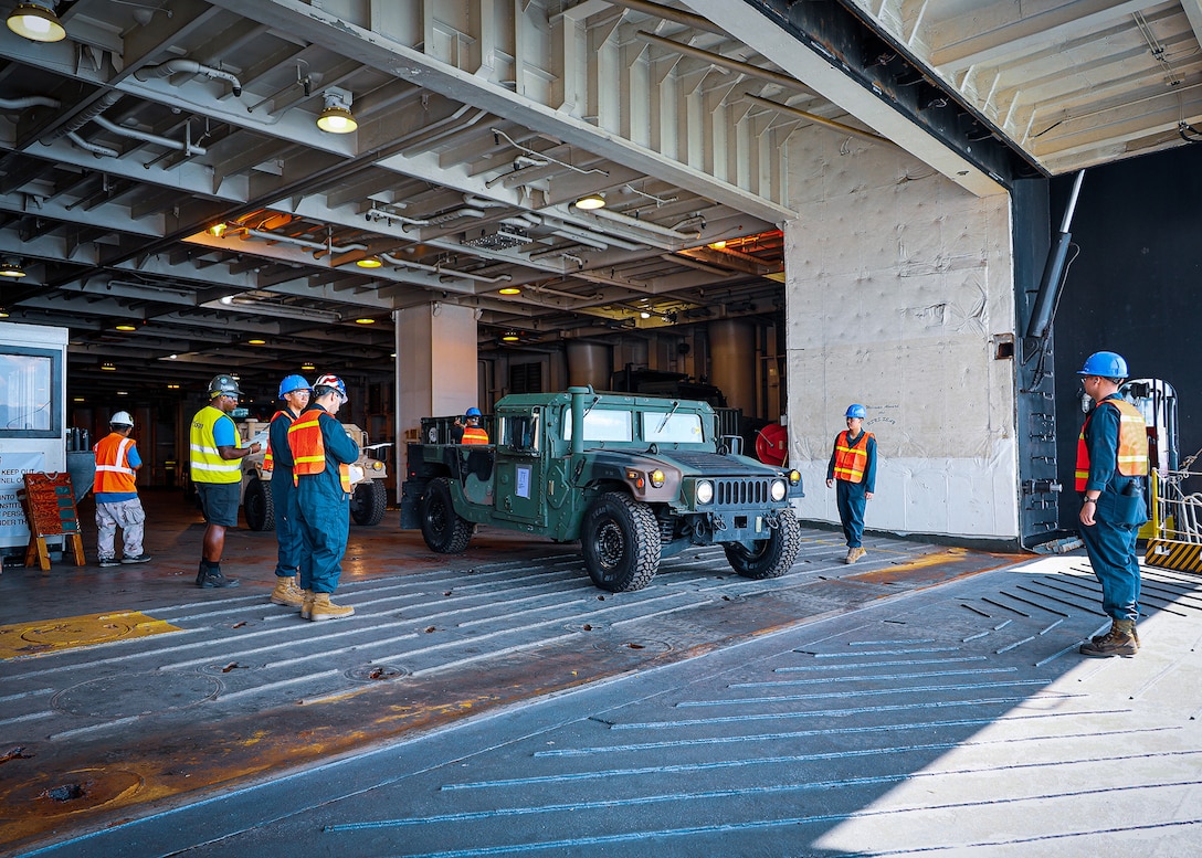 U.S. Marines assigned to I Marine Expeditionary Force stage vehicles during a maritime prepositioning force offload March 14, 2026, at the Port of Cagayan de Oro, Philippines. The operation supported the rapid distribution of forward-positioned equipment for Exercise Balikatan 2026 and demonstrated how prepositioning processes support distributed sustainment by conducting offload, distribution and regeneration across afloat platforms, ashore nodes and transportation networks. Balikatan is a longstanding annual exercise between the Armed Forces of the Philippines and the U.S. military designed to strengthen the alliance, improve combined capabilities and demonstrate commitment to regional security and stability. (U.S. Marine Corps photo by Cpl. Nicholas Martinez)