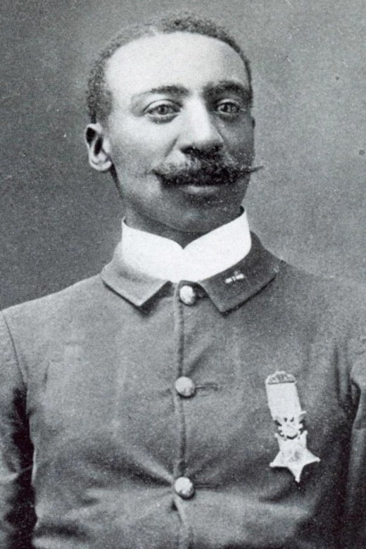 A black and white photo of a man posing for a portrait in his military dress uniform. The Medal of Honor is pinned on the man's uniform.