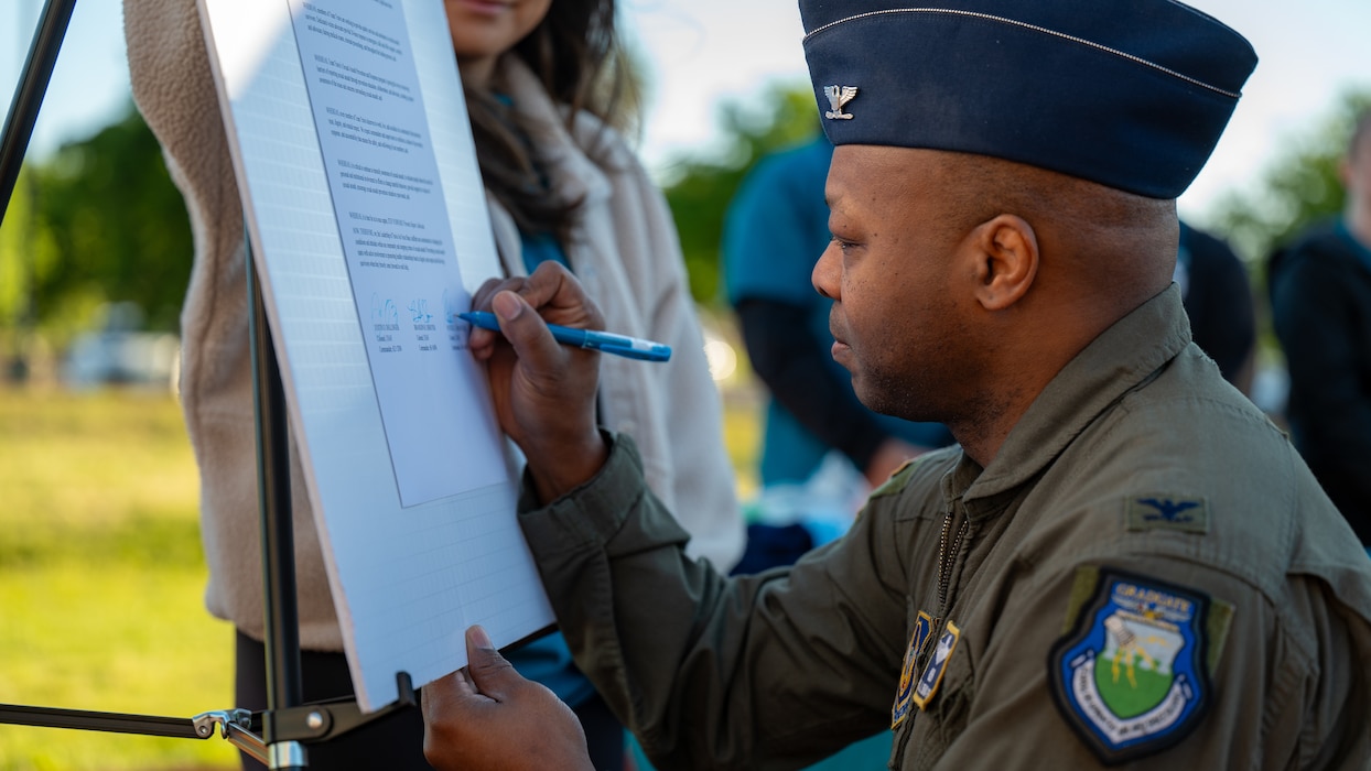 A commander signs a document