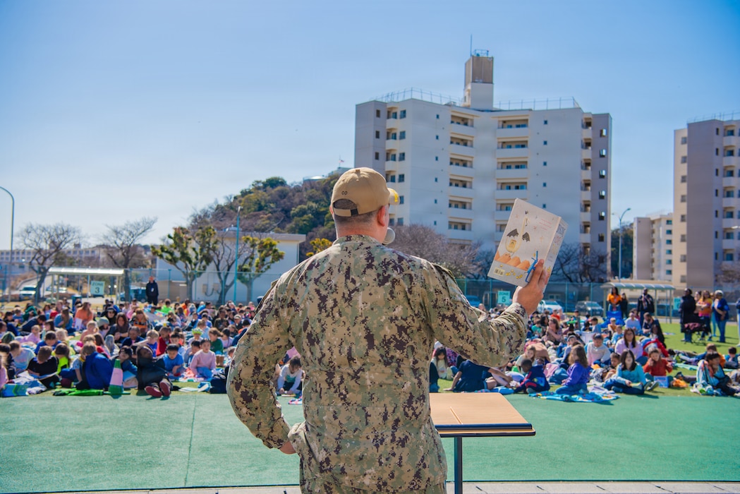 YOKOSUKA, Japan (March 5, 2026) – Commander, Fleet Activities Yokosuka, Capt. Jonathan Hopkins, reads to students at Sullivan’s Elementary School during a reading event on March 5, 2026. Capt. Hopkins visited the school field to read a few stories and encourage a love of reading, giving students the opportunity to interact with installation leadership while reinforcing the command’s support for military families and education. (U.S. Navy photo by Sheryl Sullivan)