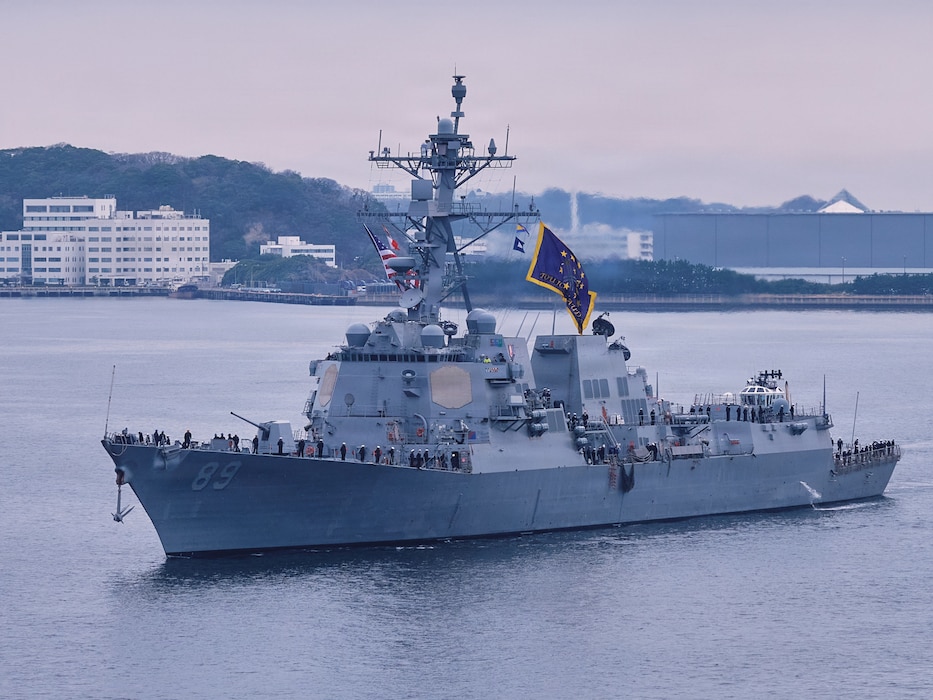 FLEET ACTIVITIES YOKOSUKA, Japan (March 23, 2026) - U.S. Navy Sailors assigned to Arleigh Burke-class guided-missile destroyer USS Mustin (DDG 89) man the rails as the ship arrives in Yokosuka, Japan, March 23, 2026. Mustin's forward-deployment to Yokosuka is part of a scheduled rotation of forces in the Pacific and supports the United States' commitment to the defense of Japan, enhances regional deterrence and ensures the U.S. Navy maintains a combat credible force ready to operate in a contested environment. (U.S. Navy photo by James Kimber)