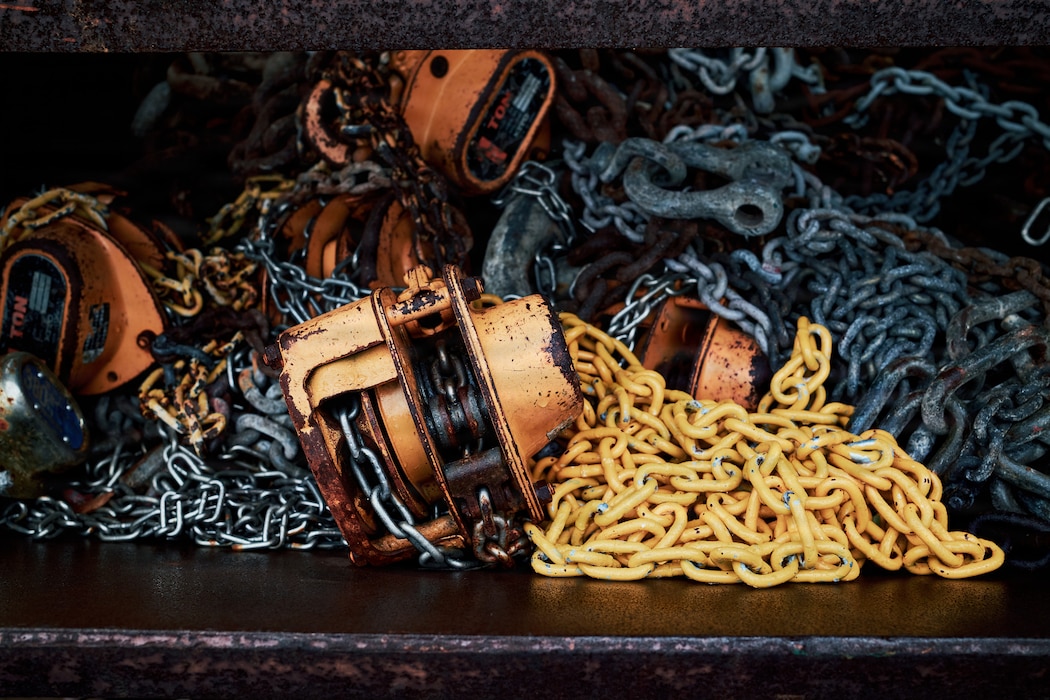 FLEET ACTIVITIES YOKOSUKA, Japan (April 2, 2026) -- Chains and hoists rest in a hopper at Commander, Fleet Activities Yokosuka's Qualified Recycling Program (CFAY QRP) Yard April 2, 2026. CFAY QRP collects materials including scrap metal, used cooking oil, batteries, and other hazardous solid waste that can be sold to for reuse in industrial environments. In 2025, CFAY QRP generated approximately $1.1 million in funds by diverting eligible solid waste from landfills and into recycling centers. The raised funds may be invested back into the installation's environmental, safety and quality-of-life programs. (U.S. Navy photo by James Kimber)