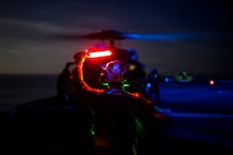 U.S. Navy Aviation Machinist’s Mate Airman Apprentice Colin Taylor, signals to a MH-60S Seahawk, assigned to Helicopter Sea Combat Squadron (HSC) 8, on the flight deck of the Nimitz-class aircraft carrier USS Theodore Roosevelt (CVN 71), April 4, 2026.