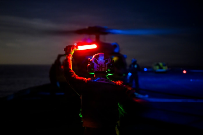 U.S. Navy Aviation Machinist’s Mate Airman Apprentice Colin Taylor, signals to a MH-60S Seahawk, assigned to Helicopter Sea Combat Squadron (HSC) 8, on the flight deck of the Nimitz-class aircraft carrier USS Theodore Roosevelt (CVN 71), April 4, 2026.