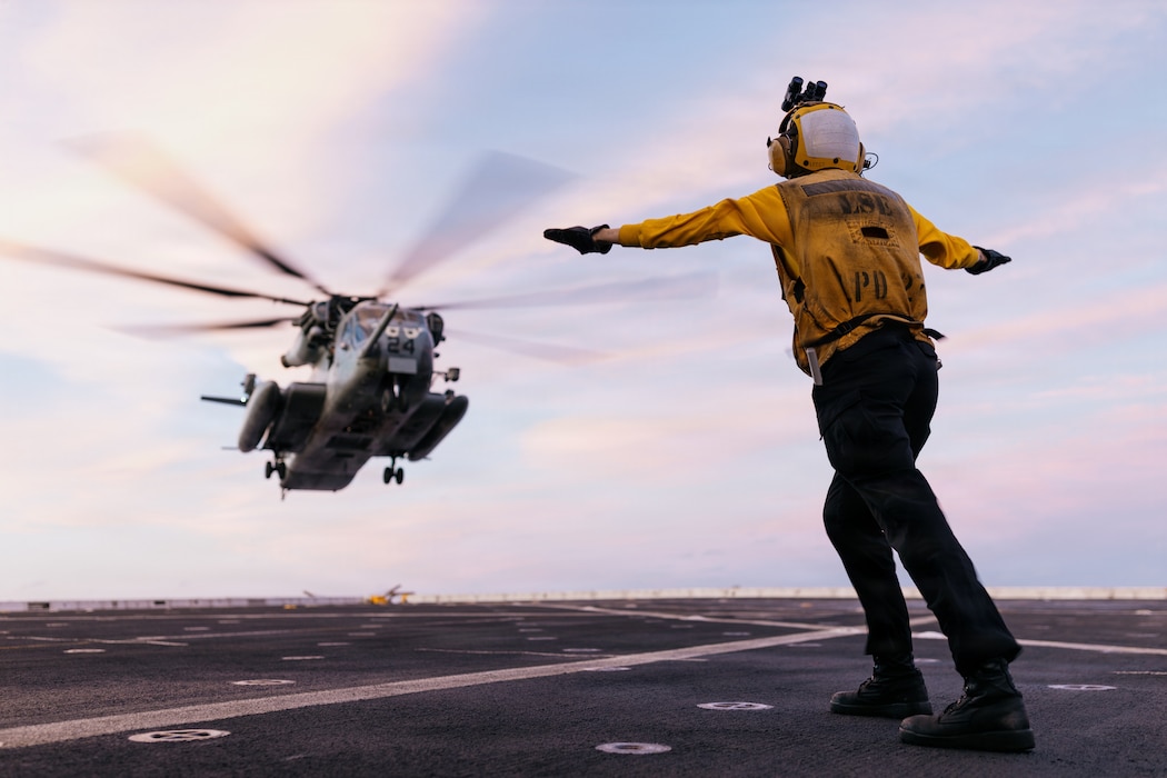 U.S. Navy Aviation Boatswain’s Mate (Handling) 3rd Class Savannah Edwards, assigned to San Antonio-class amphibious transport dock ship USS Portland (LPD 27), lands a CH-53E Super Stallion with Marine Medium Tiltrotor Squadron (VMM) 163 (Reinforced), 11th Marine Expeditionary Unit, during flight deck operations in the Pacific Ocean, April 2, 2026.