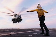 U.S. Navy Aviation Boatswain’s Mate (Handling) 3rd Class Savannah Edwards, assigned to San Antonio-class amphibious transport dock ship USS Portland (LPD 27), lands a CH-53E Super Stallion with Marine Medium Tiltrotor Squadron (VMM) 163 (Reinforced), 11th Marine Expeditionary Unit, during flight deck operations in the Pacific Ocean, April 2, 2026.