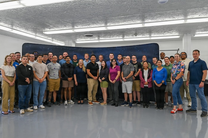 2nd Space Launch Squadron personnel pose for a group photo at The Crucible innovation lab.