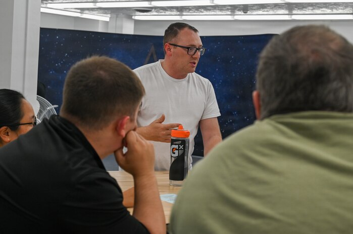 U.S. Air Force Tech. Sgt. Phillip Noe, 2nd Space Launch Squadron mission assurance technician, speaks to his team.