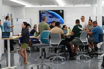 2nd Space Launch Squadron personnel discuss ideas in breakout teams during their first Innovation Days stand down event at The Crucible innovation lab.