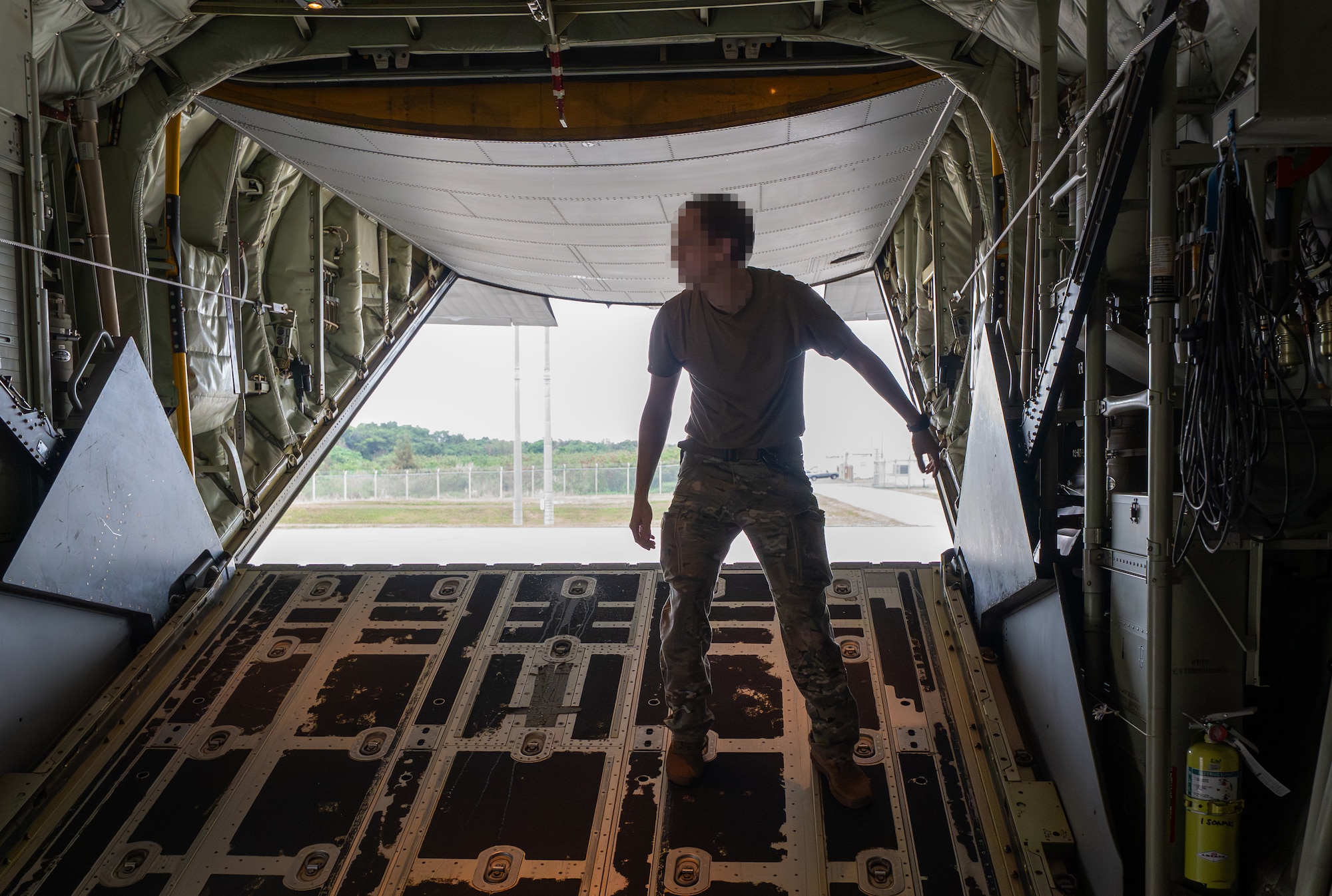 A U.S. Air Force loadmaster assigned to the 353rd Special Operations Wing performs preflight checks before takeoff at Kadena Air Base, Japan.