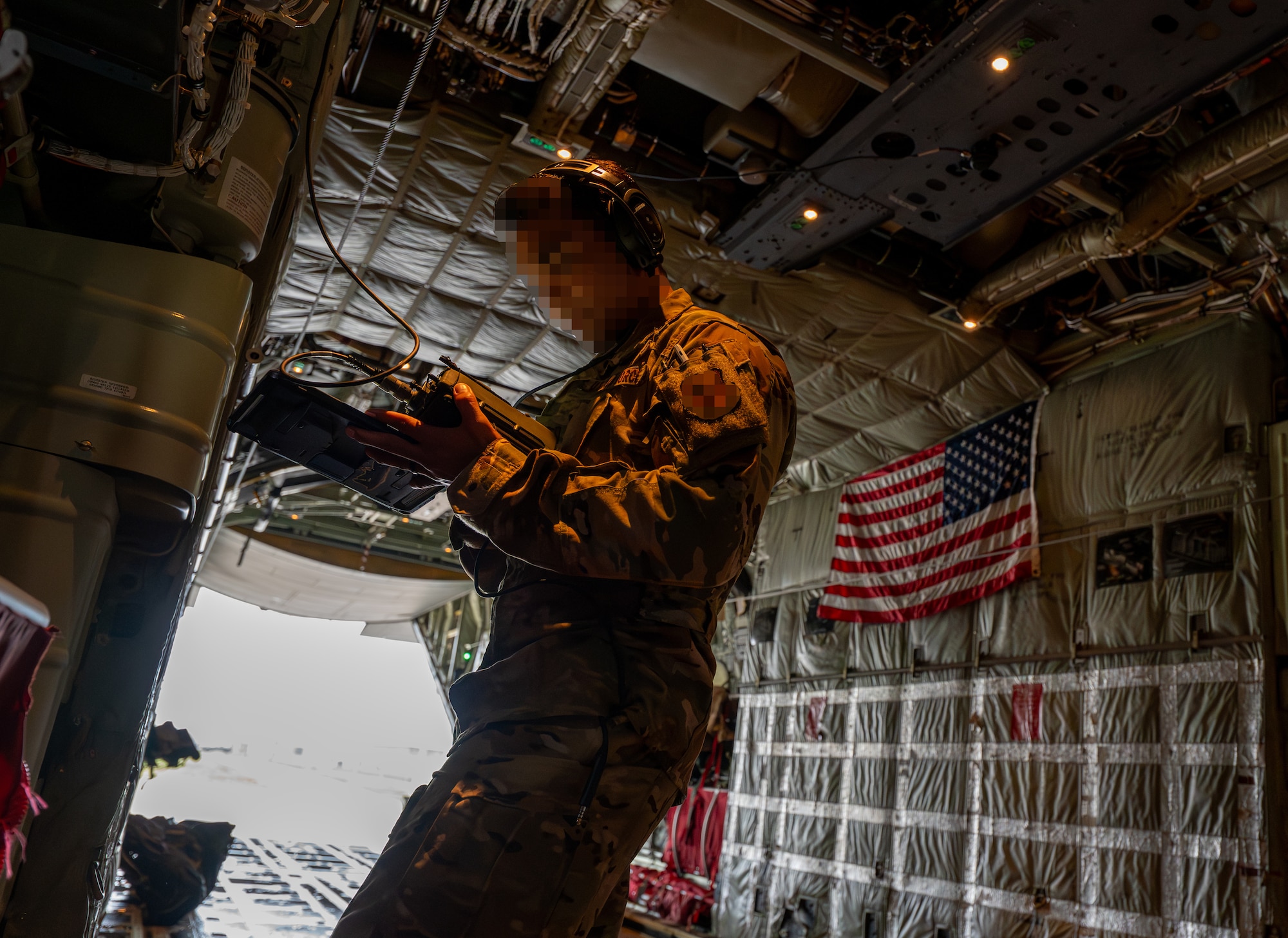 A U.S. Air Force MC-130J Commando II pilot assigned to the 353rd Special Operations Wing performs preflight checks before takeoff at Kadena Air Base, Japan.