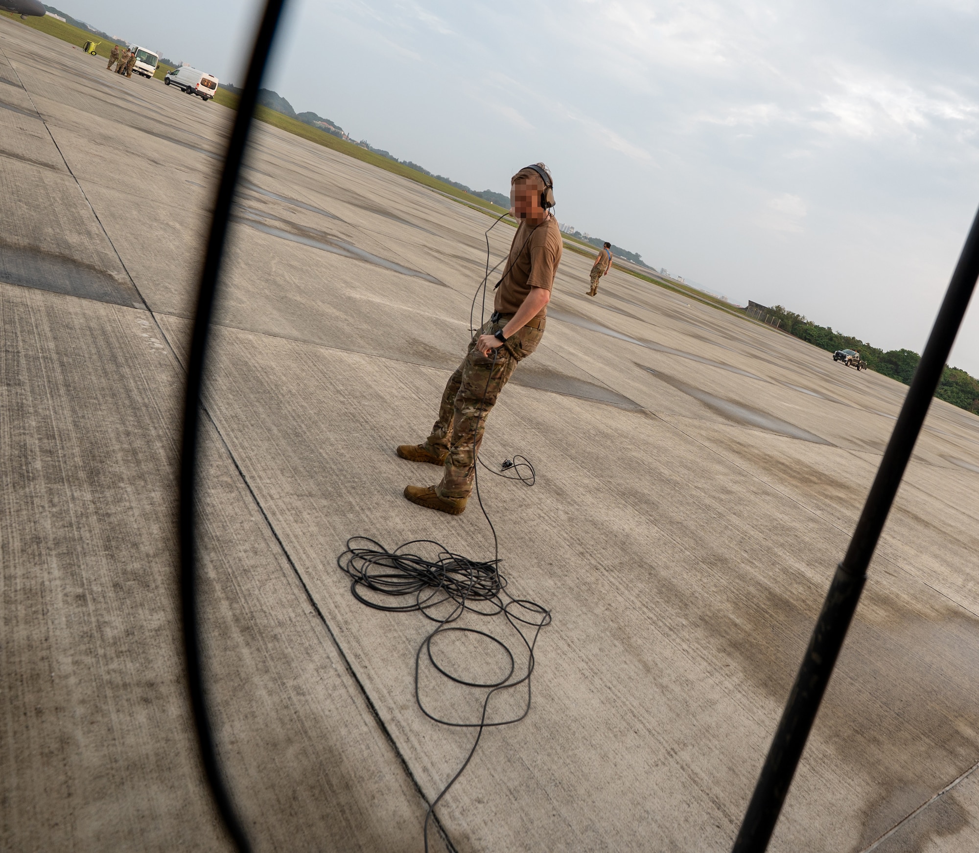 A U.S. Air Force loadmaster assigned to the 353rd Special Operations Wing performs preflight checks before takeoff at Kadena Air Base, Japan.