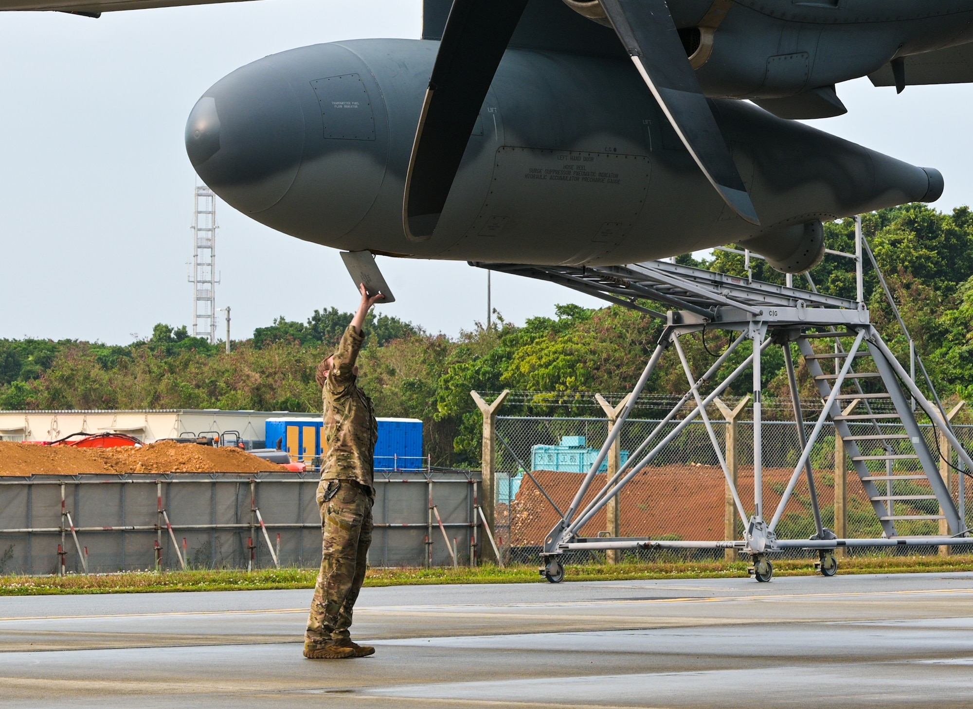 A U.S. Air Force loadmaster assigned to the 353rd Special Operations Wing performs preflight checks before takeoff at Kadena Air Base, Japan.