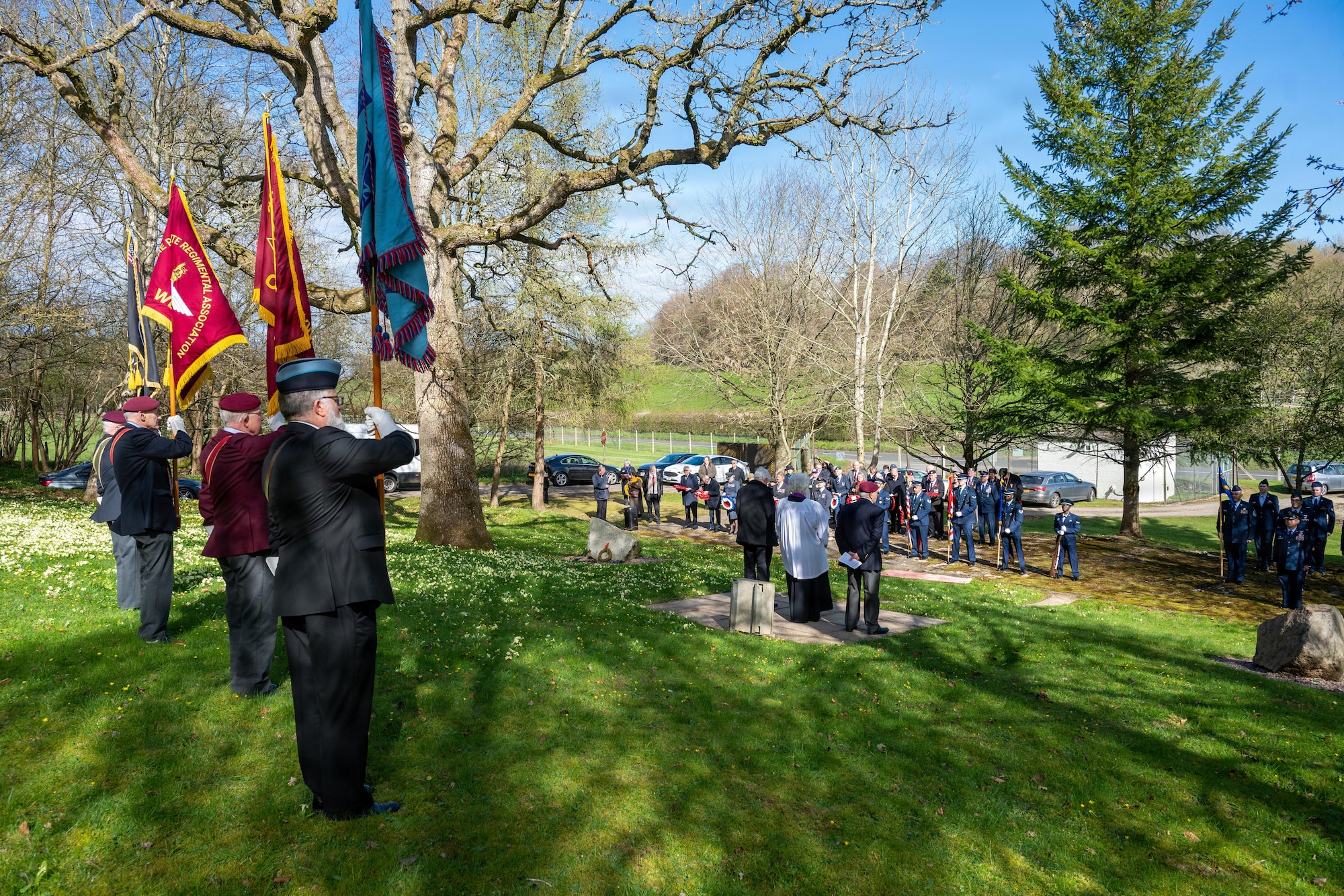 Members of the 501st Combat Support Wing and the local community stand during a memorial service