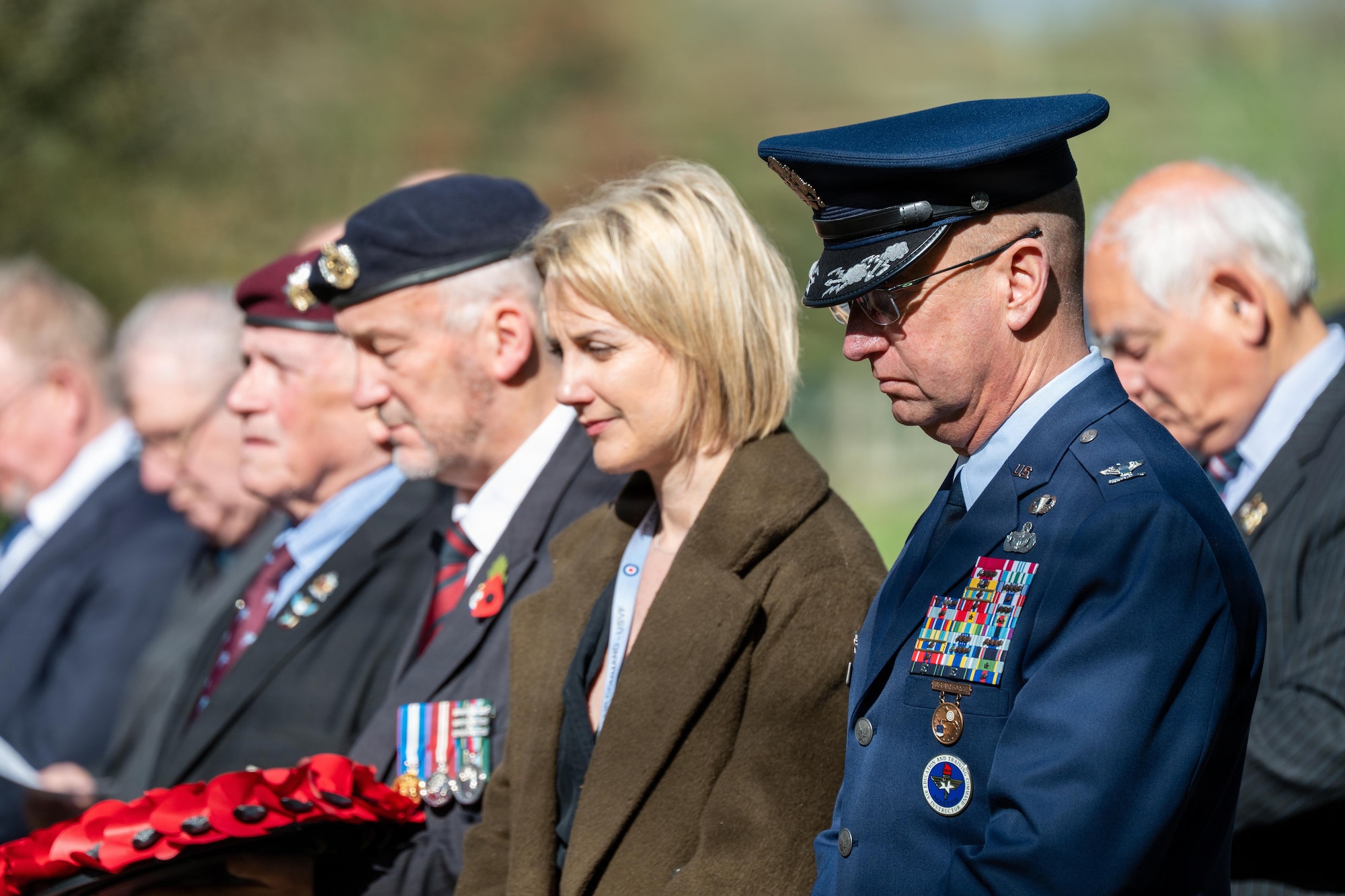 A USAF officer bows his head in prayer during a memorial service
