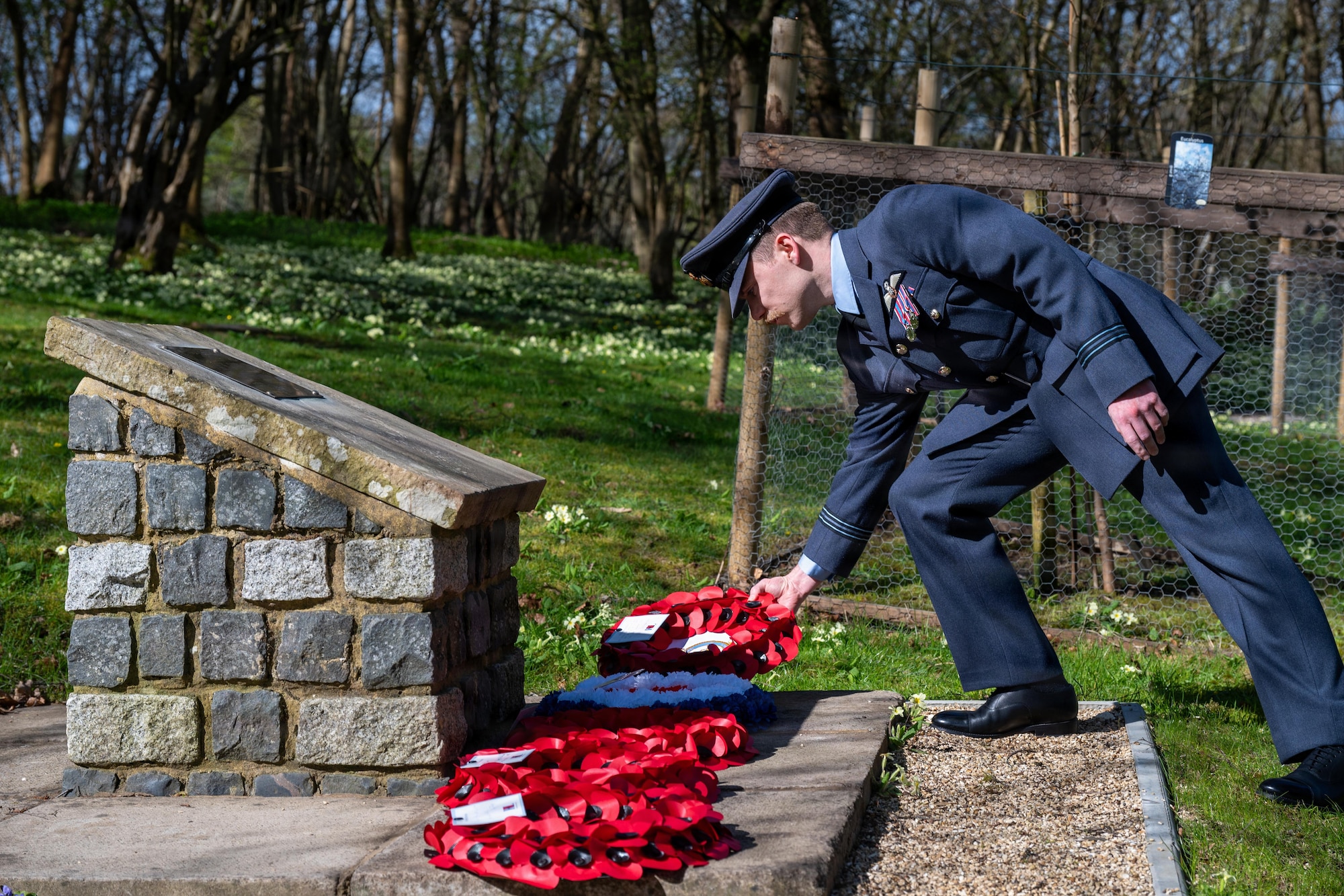 A member of the Royal Air Force lays a wreath during a memorial service