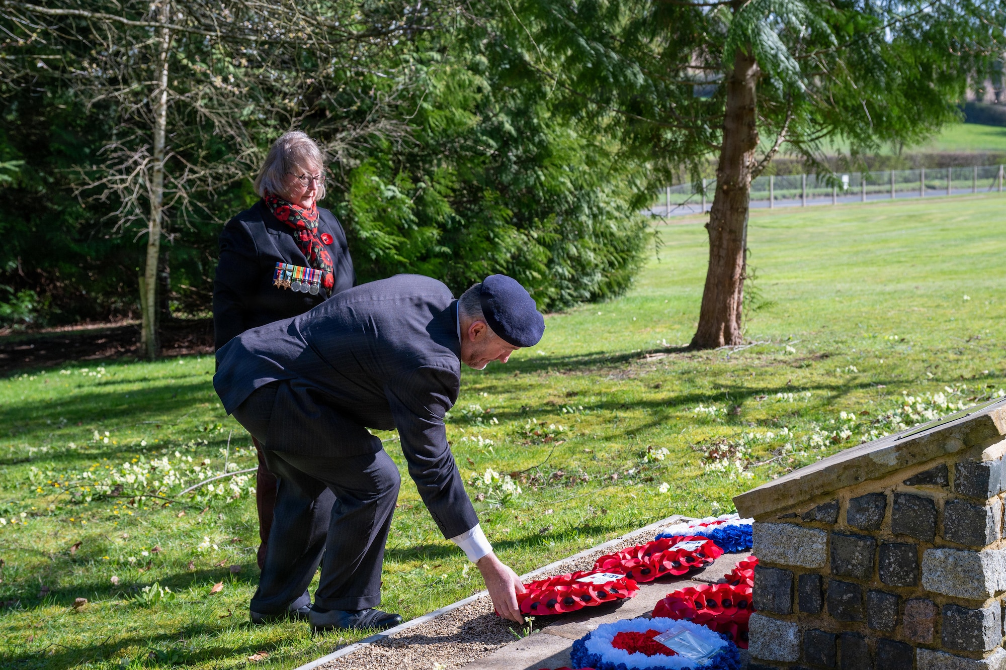 Community members lay a wreath during a memorial service