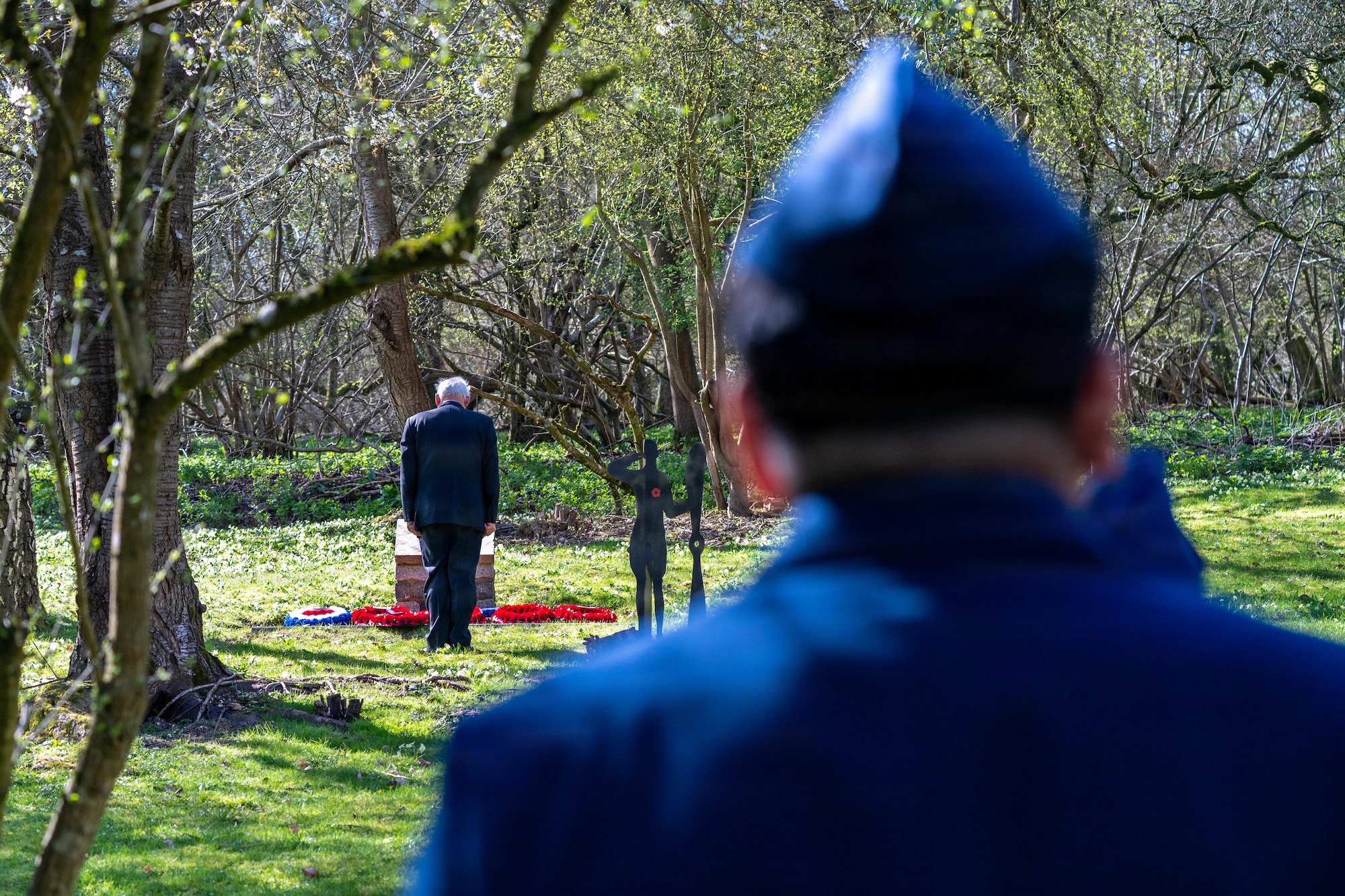 A community member pays respects during a memorial service