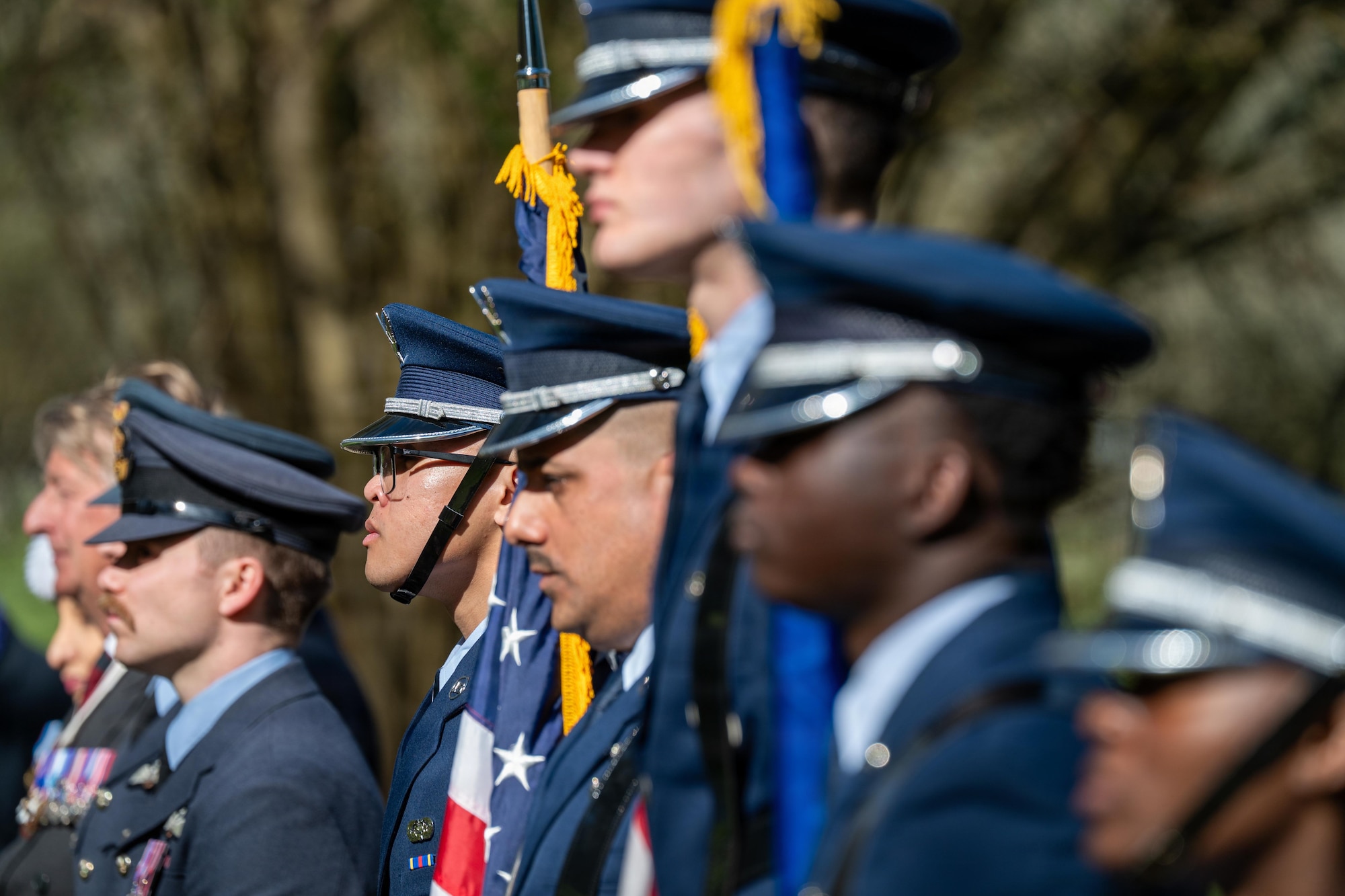 Honor guardsmen stand at attention during a memorial service