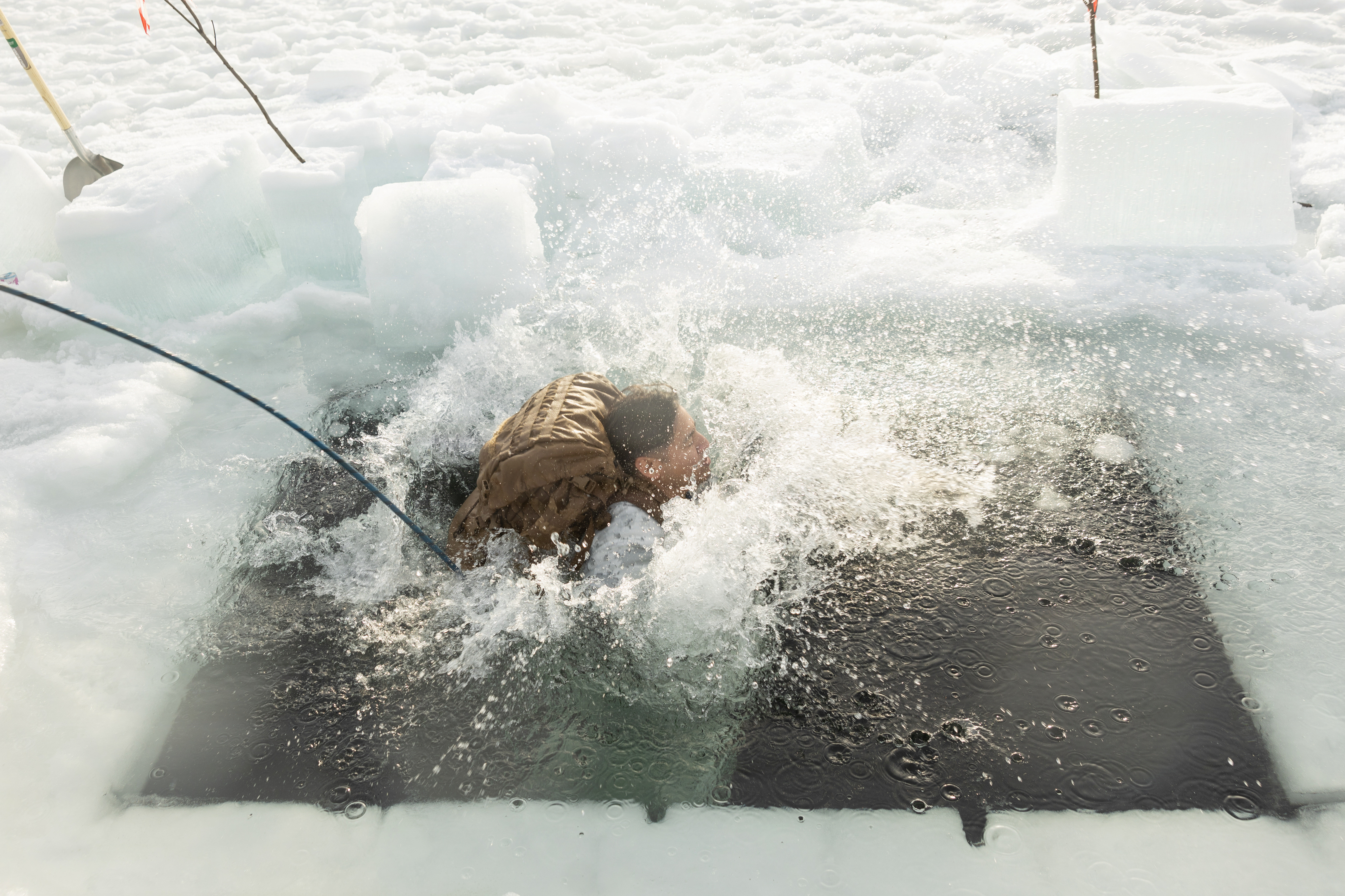 U.S. Navy Hospital Corpsman 1st Class Luis Esquivel, with 2nd Distribution Support Battalion, Combat Logistics Regiment 27, 2nd Marine Logistics Group, participates in a cold plunge near Elvegardsmoen, Norway, March 10, 2026. The training taught Marines and Sailors how to manage the effects of cold-water submersion and perform active rewarming procedures during exercise Cold Response 26. A key component of NATO's enhanced vigilance activity Arctic Sentry, exercise Cold Response 26 is a Norwegian-led winter military exercise designed to enhance collective defense capabilities and ensure U.S. readiness to rapidly deploy and seamlessly operate alongside NATO Allies in challenging arctic conditions. Esquivel is a native of Texas. (U.S. Marine Corps photo by Lance Cpl. Franco Lewis)
