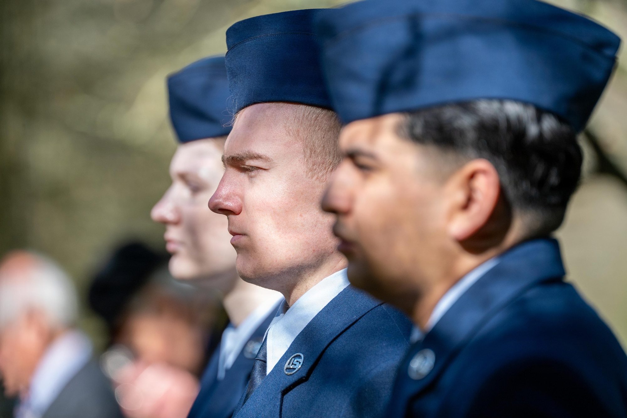 Airmen stand at attention during a memorial service