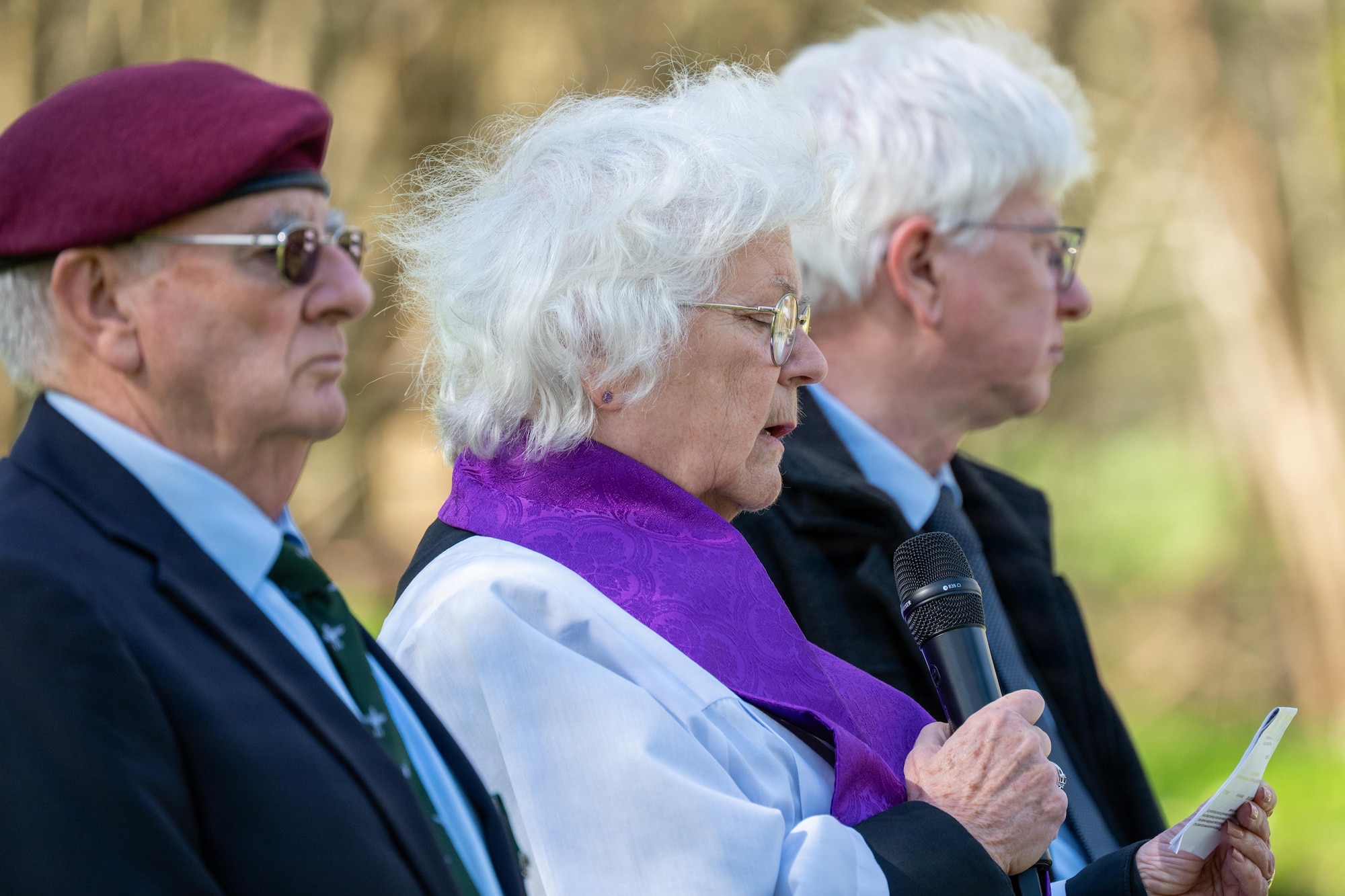 A clergy member delivers a prayer during a memorial service