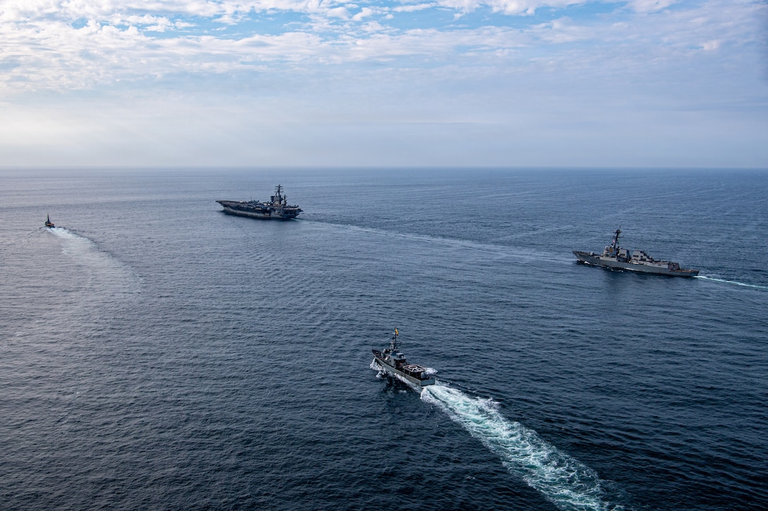 Overhead view of naval warships sailing in formation.