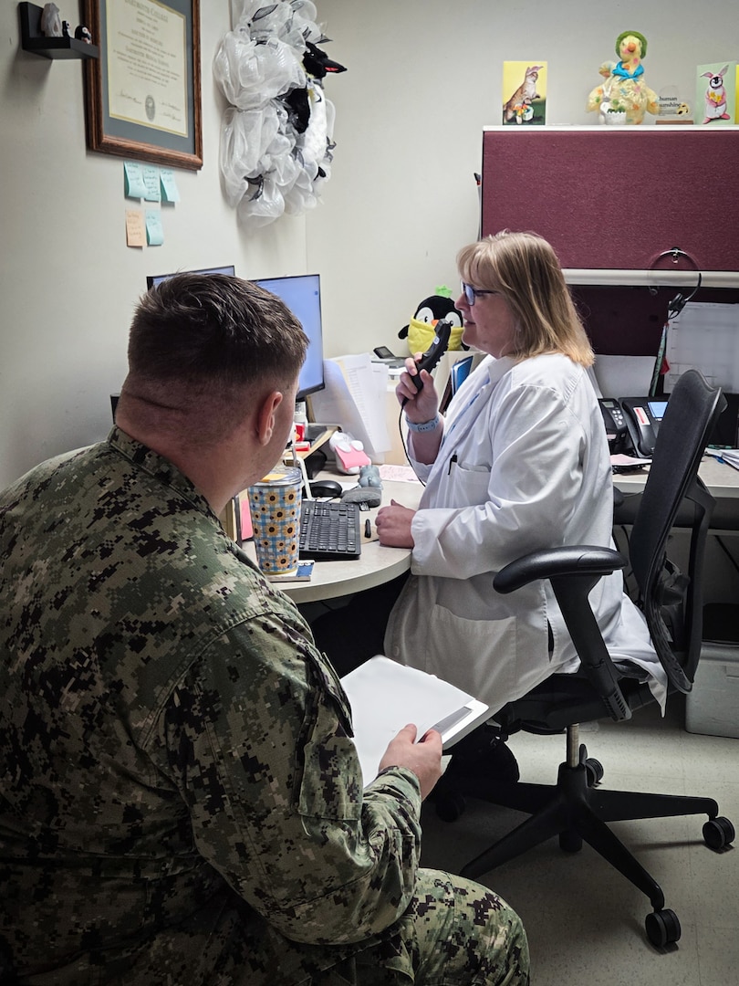 Dr. Rebecca Carlin, right, charts patient notes aboard Navy Medicine Readiness and Training Command Cherry Point on Thursday, April 2, 2026.  Carlin is a medical provider in the facility’s Patient Centered Medical Home and cares for the spouses and children of Sailors and Marines stationed at the base, helping them remain focused on training and preparing for deployment.