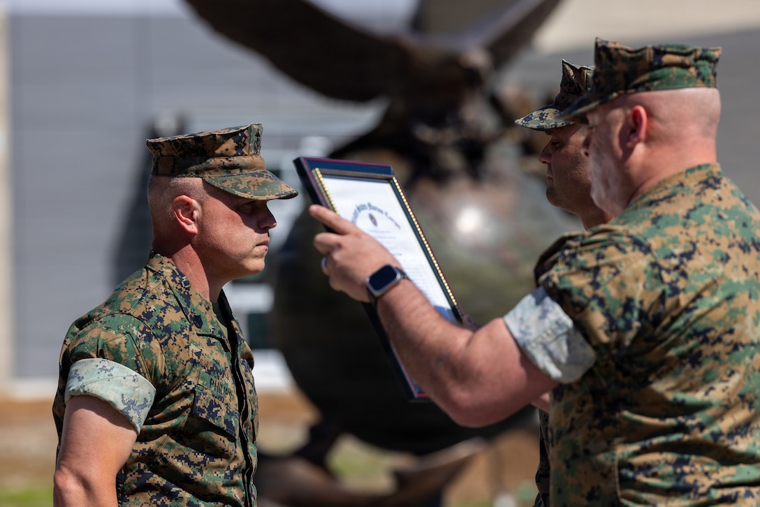 U.S. Marine Corps Sgt. Maj. Juan Vasquez Jr., right, senior enlisted leader of Combat Logistics Battalion 25, Combat Logistics Regiment 2, 2nd Marine Logistics Group, reads a meritorious promotion warrant for Gunnery Sgt. Bobby Philips Jr., motor transport chief, 4th Light Armored Reconnaissance Battalion, 4th Marine Division during a meritorious promotion ceremony in Jacksonville, North Carolina, April 2, 2026. Philips was selected for meritorious promotion spanning across Marine Forces Reserve. (U.S. Marine Corps photo by Sgt. Alexander Lesko)