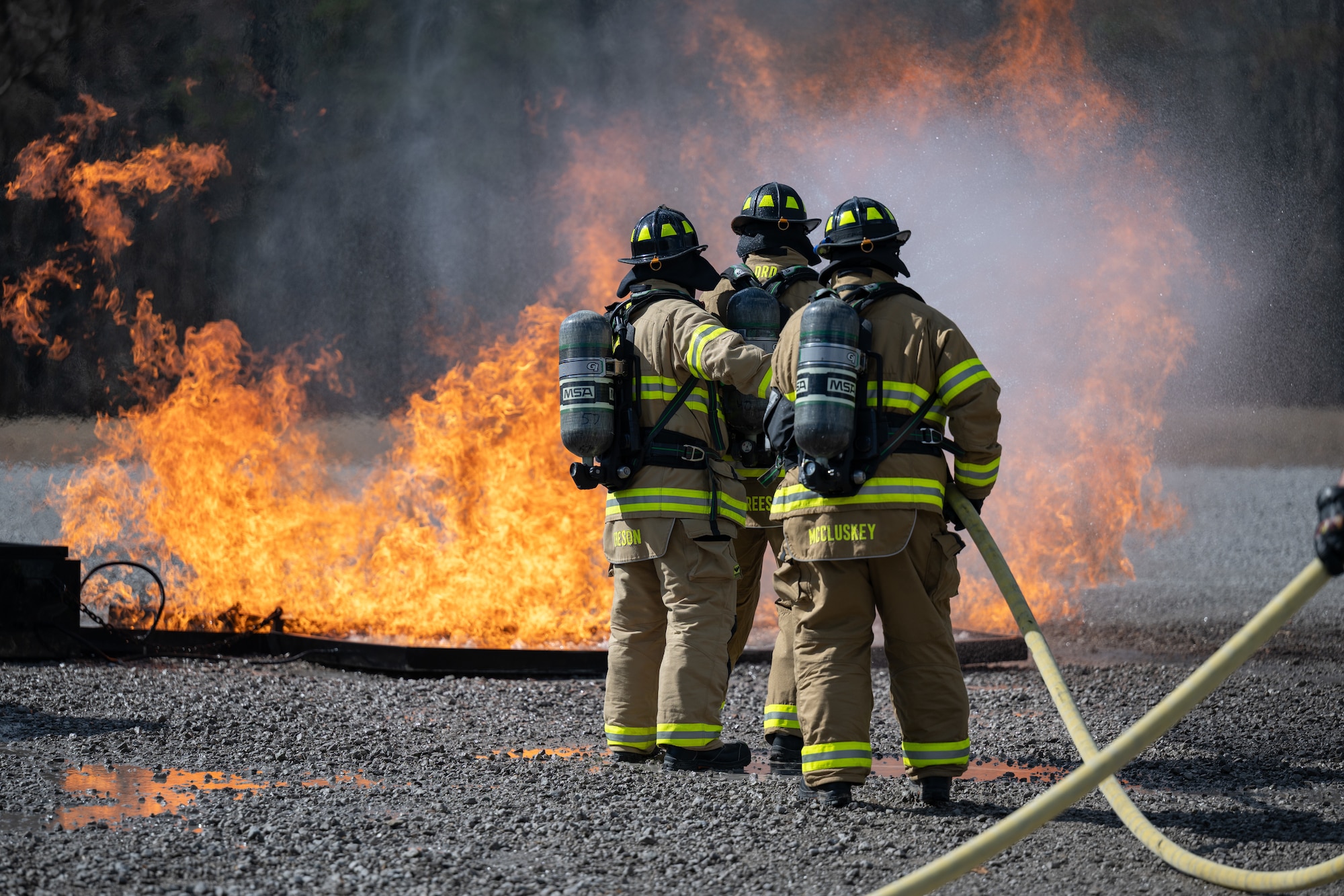 Arnold Engineering Development Complex Individual Mobilization Augmentee Col. Aaron Stevenson, center, is joined by Arnold Air Force Base Fire and Emergency Services firefighters Curtis Creson and Stephen McCluskey to combat a simulated running aircraft fuel fire during live fire training March 6, 2026, at Arnold AFB, Tenn. AEDC leadership once again participated in the annual training which is conducted by FES to maintain readiness in the event of an emergency and to meet National Fire Protection Association and Air Force requirements. Arnold AFB is the headquarters of AEDC. (U.S. Air Force photo by Keith Thornburgh)