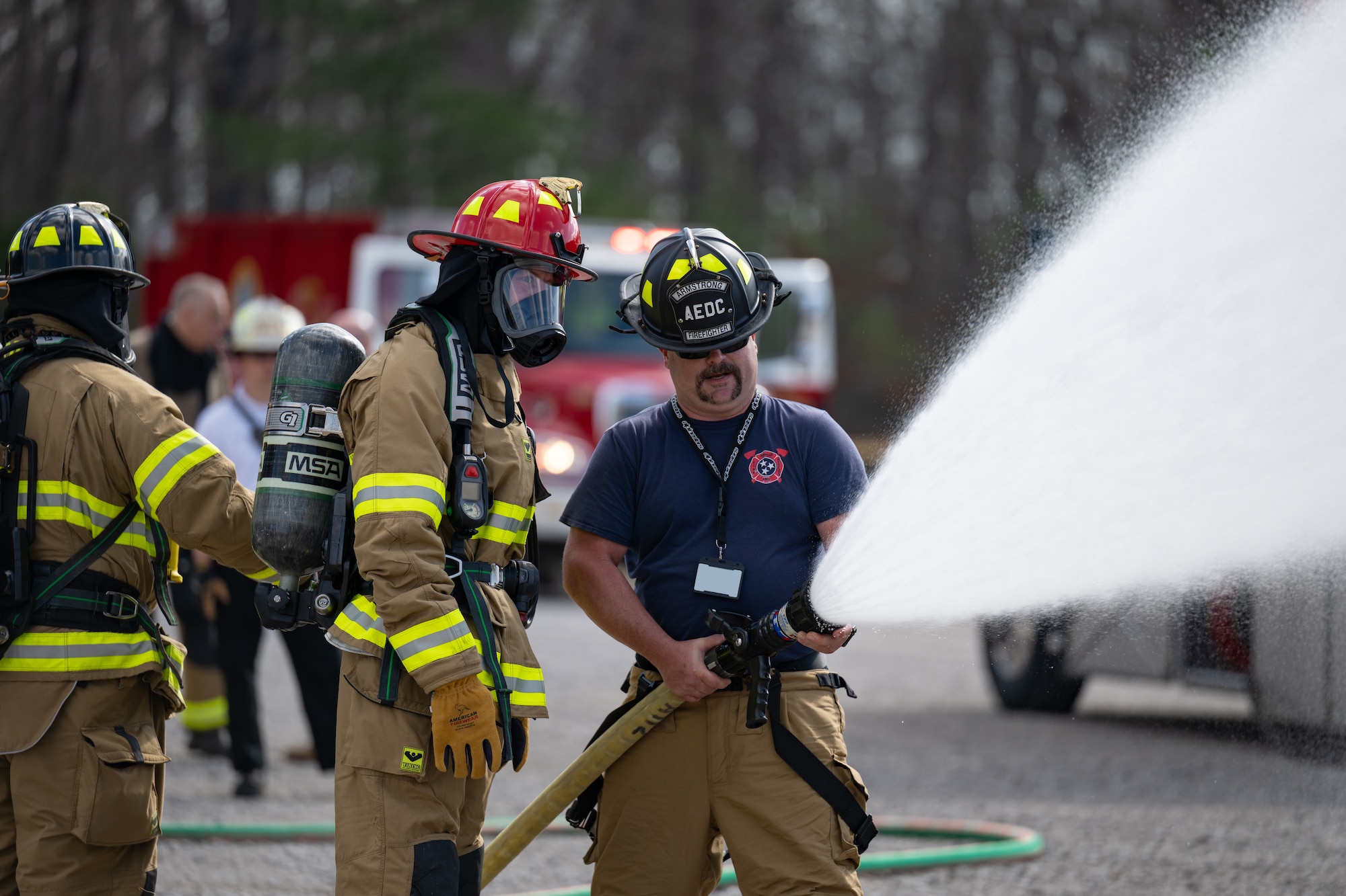 Arnold Engineering Development Complex Commander Col. Grant Mizell, center, receives firehose instruction from Arnold Air Force Base Fire and Emergency Services firefighter Charles Armstrong prior to his participation in live fire training March 6, 2026, at Arnold AFB, Tenn. During the training, Arnold FES crews combated fires on a simulated aircraft fuselage. The annual training is conducted by FES to maintain readiness in the event of an emergency and to meet National Fire Protection Association and Air Force requirements. Arnold AFB is the headquarters of AEDC. (U.S. Air Force photo by Keith Thornburgh)