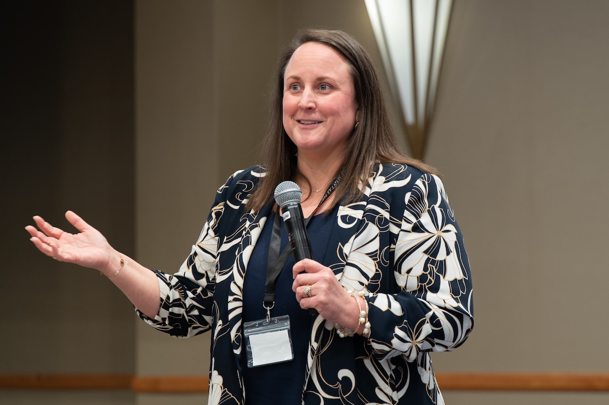 Image of a person speaking to a crowd.
