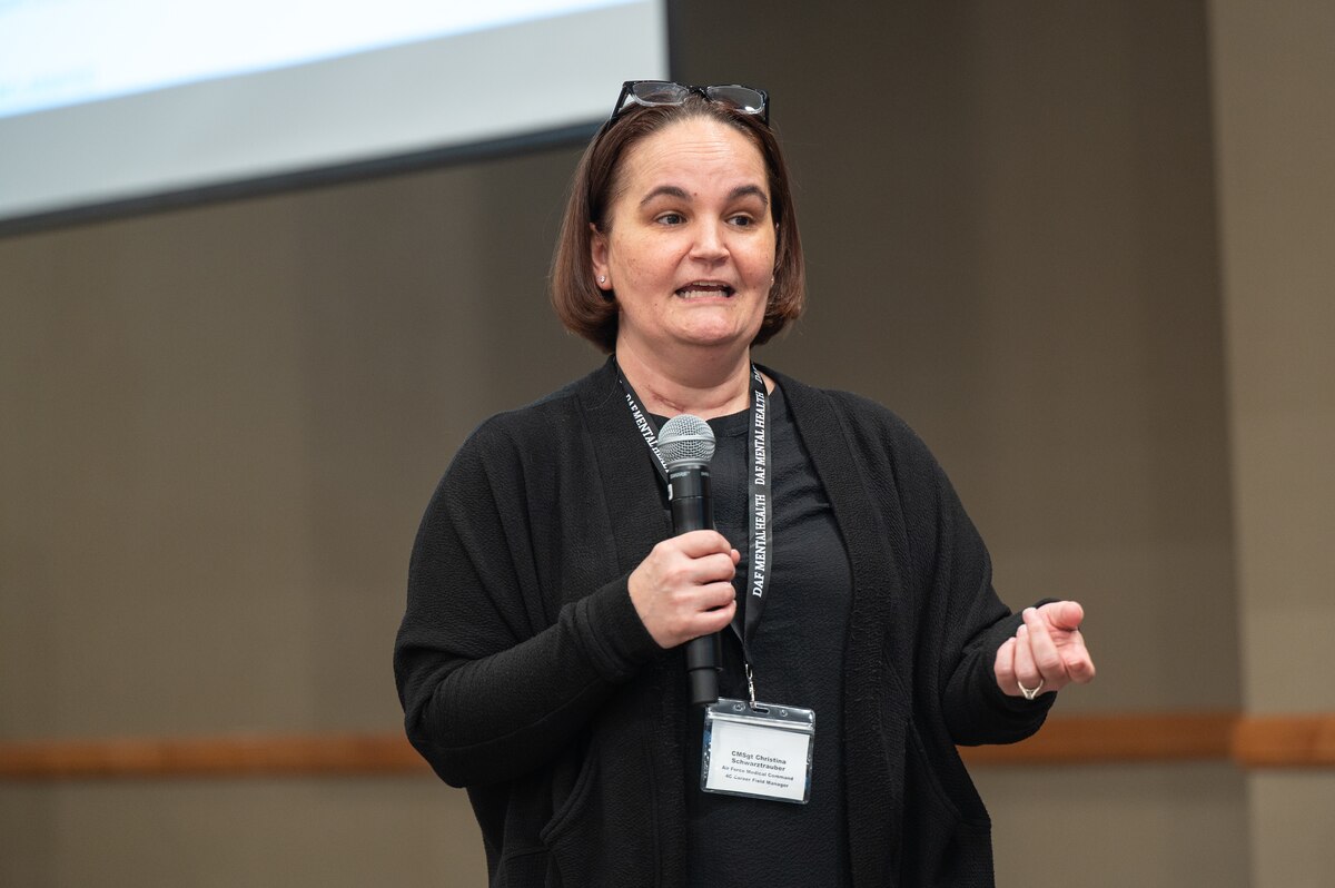 Image of a person speaking to a crowd.