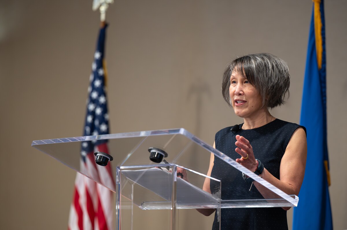Image of a person speaking to a crowd.