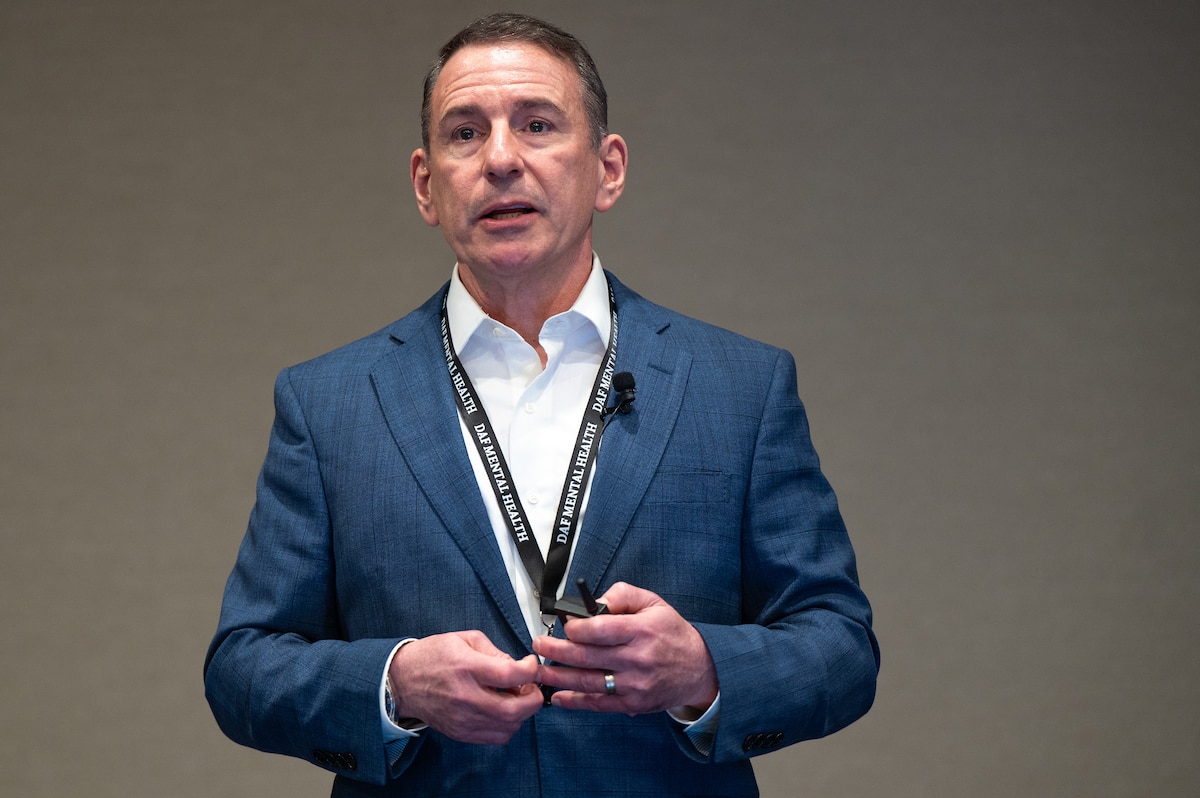 Image of a person speaking to a crowd.