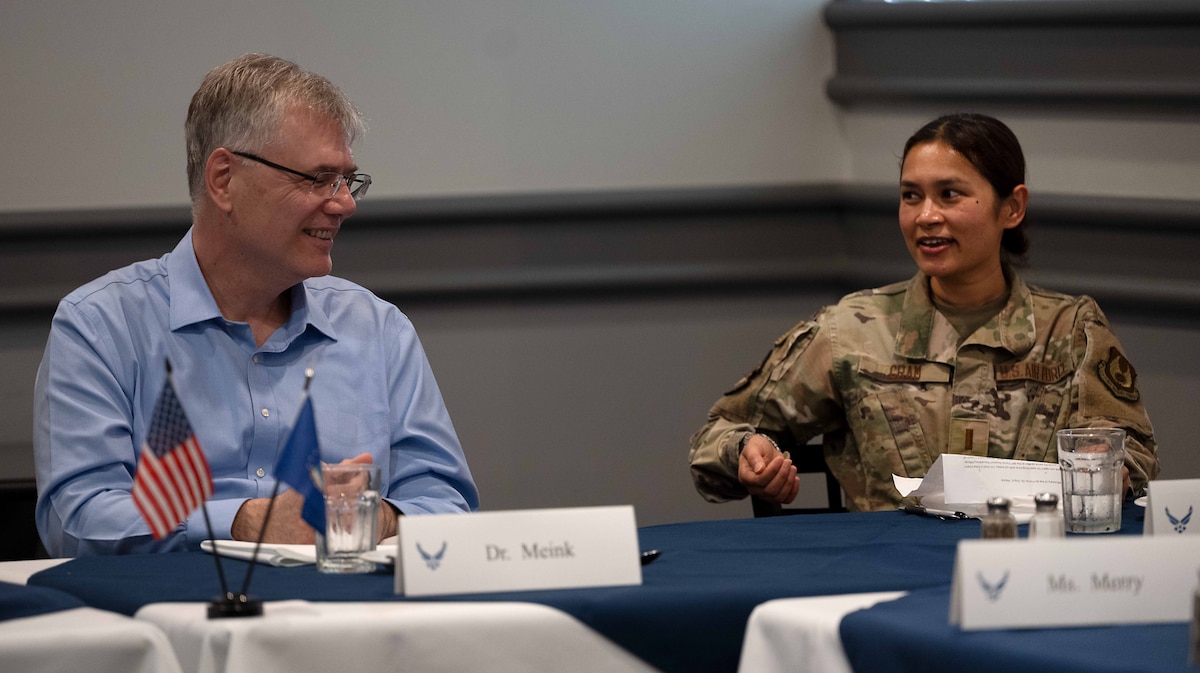 two people at table talking