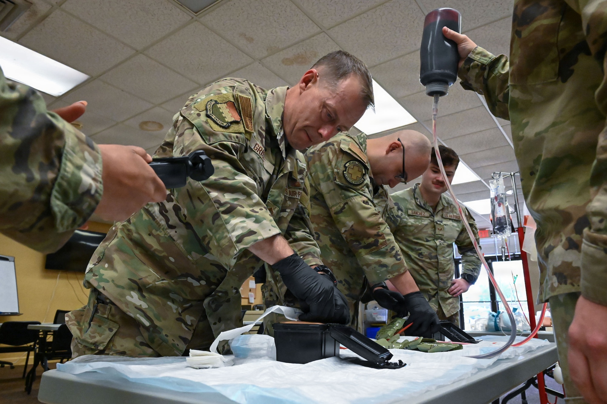 Airmen practice packing a wound