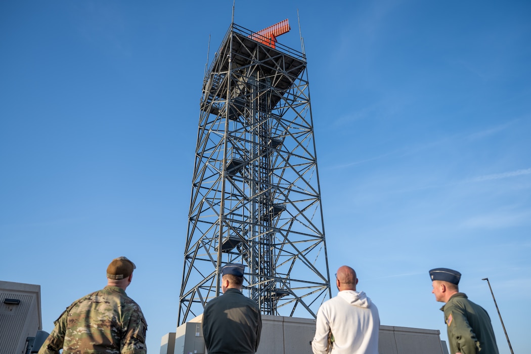 The 97th Air Mobility Wing command team looks up at the digital airport surveillance radar during an immersion tour with 97th Operations Support Squadron leadership at Altus Air Force Base, Oklahoma, March 30, 2026. The radar provided surveillance data to air traffic controllers supporting flight operations at Altus AFB. (U.S. Air Force photo by Airman 1st Class Nathan Langston)