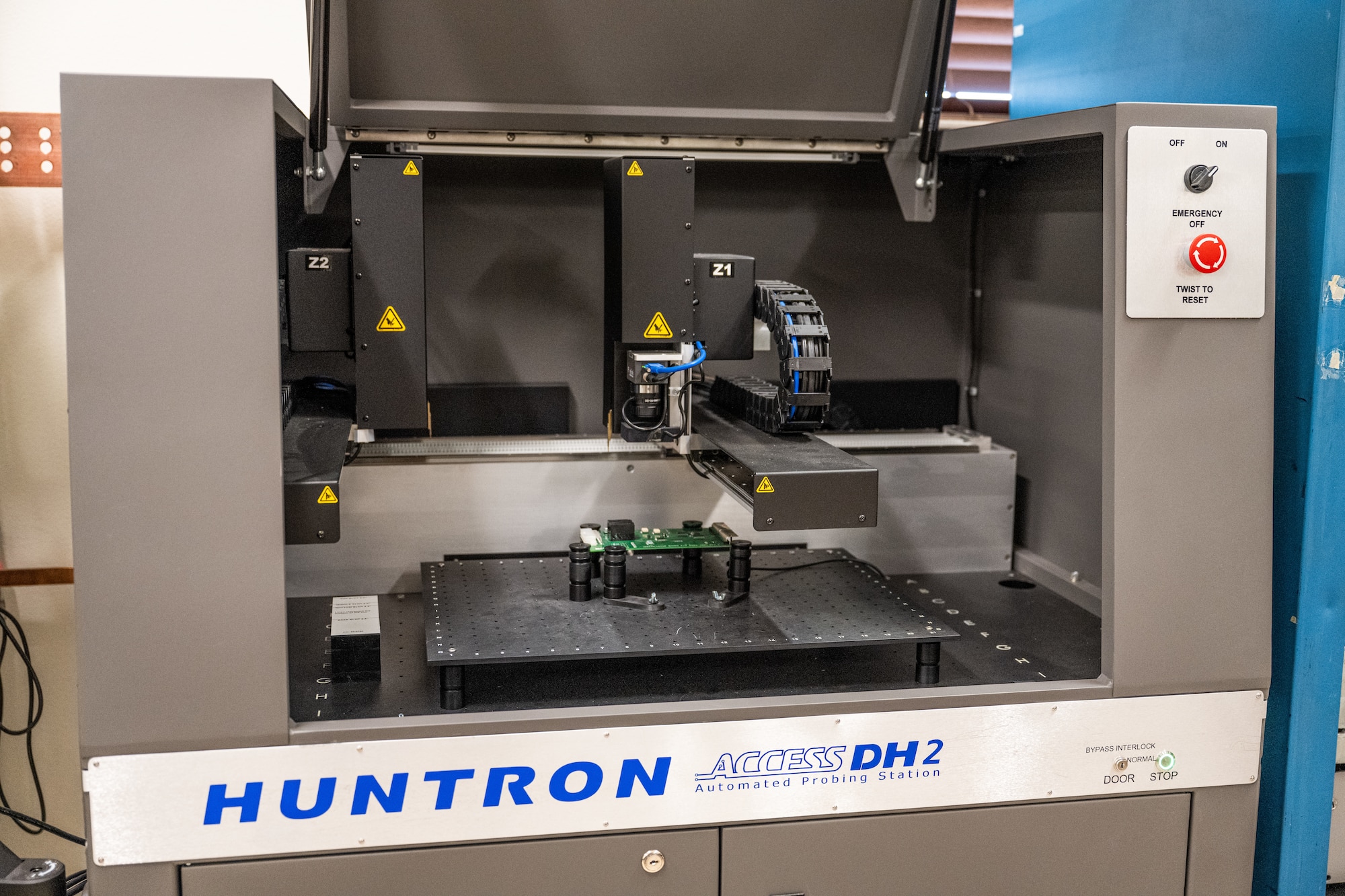A Huntron Access DH2 automated probing station initializes at Dyess Air Force Base, Texas, March 23, 2026. The system is used to analyze circuit cards and identify faults by comparing electrical signatures to known serviceable components. (U.S. Air Force photo by Airman 1st Class Caleb Schellenberg)