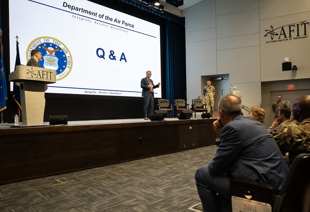 person speaking to audience from a stage