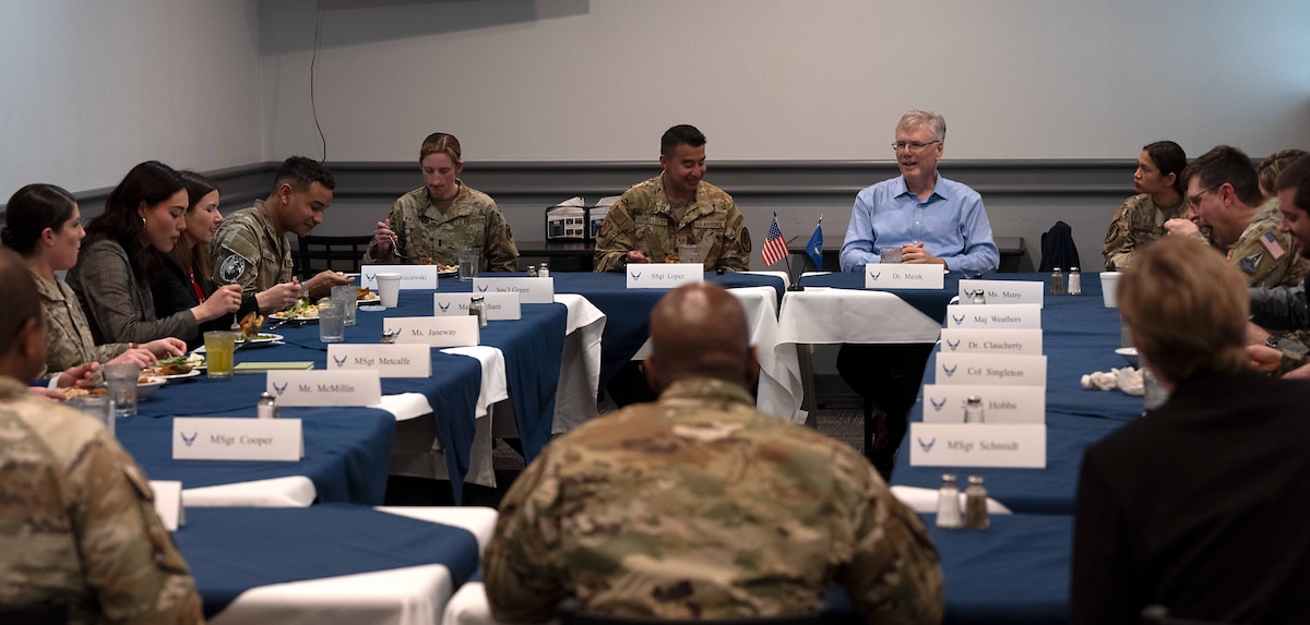 people eating and talking at a table