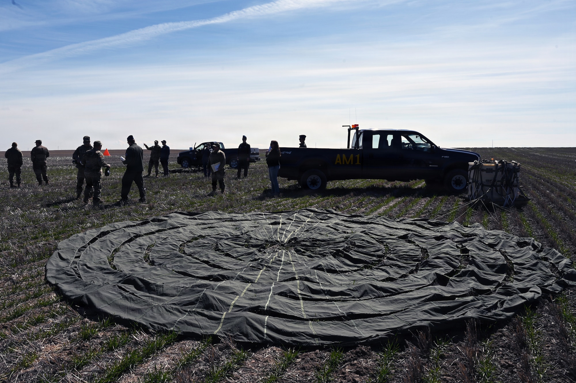 Attendees observe C-130H aircraft assigned to the 120th Airlift Wing conducting aerial delivery operations over the Vigilante Drop Zone near Power, Montana, April 6, 2026.