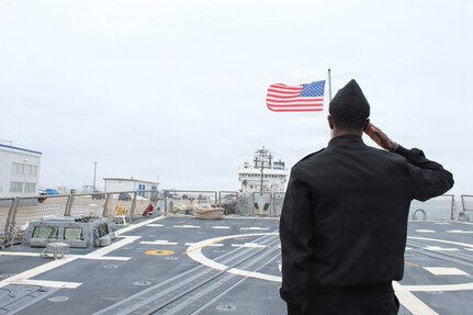 260306-N-OV429-2002 NEWPORT, R.I. (March 6, 2026) – Sailor from Navy Medicine Readiness and Training Command (NMRTC) New England, salutes the ensign during a tour onboard the future Arleigh Burke-class guided missile destroyer USS Harvey C. Barnum Jr. (DDG 124), March 6, 2026. The tour highlighted the vital role Navy Medicine plays in sustaining warfighter readiness at sea, reinforcing how medical Sailors contribute directly to mission success. NMRTC New England provides operational training to healthcare professionals through healthcare delivery to optimize both medical staff and Warfighter and readiness. (U.S. Navy photo by Hospital Corpsman Third Class Jammel Tilley)