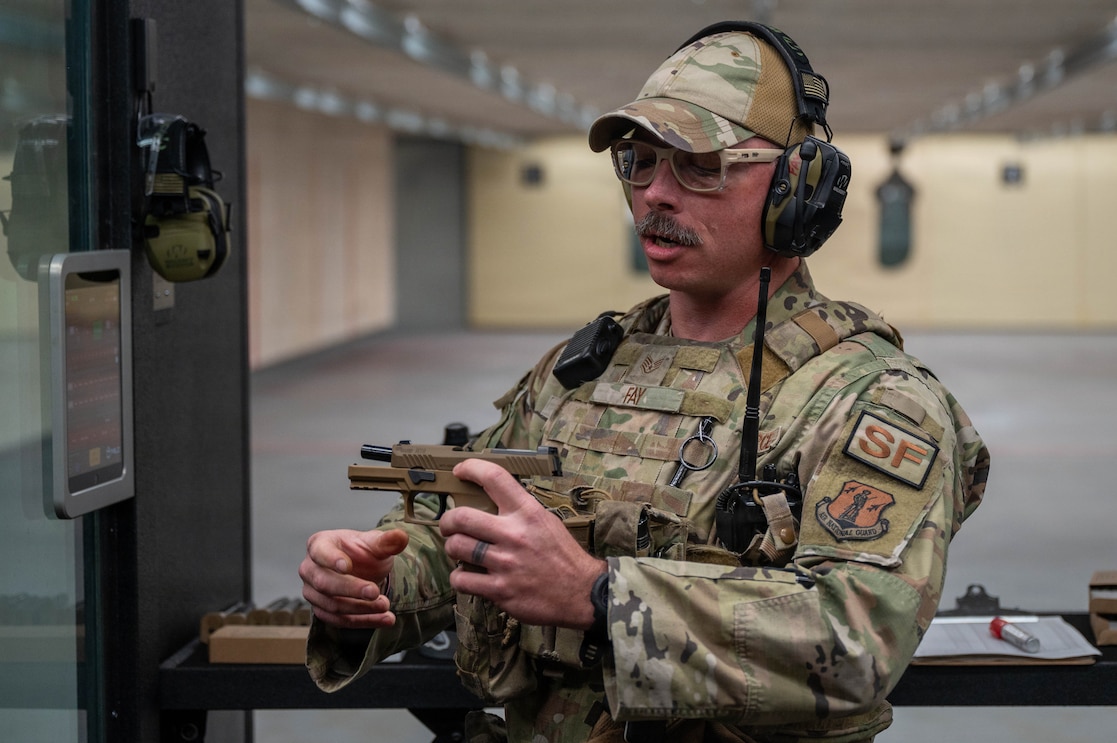 U.S. Air Force Staff Sgt. Nicholas Fay, a Combat Arms Training and Maintenance instructor assigned to the 161st Air Refueling Wing, instructs Airmen on the use of a Sig Sauer M18 pistol during the marksmanship portion of the German Armed Forces Proficiency Badge assessment at Goldwater Air National Guard Base, Phoenix, April 2, 2026. The GAFPB is a decoration of the Bundeswehr, the Armed Forces of the Federal Republic of Germany, and is one of few foreign military badges authorized to be worn by U.S. Air Force, Army, and Space Force members.
 (U.S. Air National Guard photo by Airman 1st Class Jacob Hreshchyshyn)