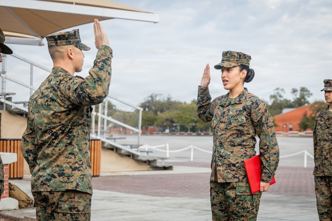 U.S. Marine Corps Cpl. Erin Porras, a Marine with Headquarters Company, Headquarters and Service Battalion, recites the oath of enlistment during a reenlistment ceremony on Marine Corps Recruit Depot Parris Island, S.C., Feb. 19, 2026. The reenlistment ceremony serves to highlight Marines who continue their service, and it reaffirms the core values of honor, courage, and commitment to the Corps and to the nation.(U.S. Marine Corps photo by Cpl. Jordy Morales)