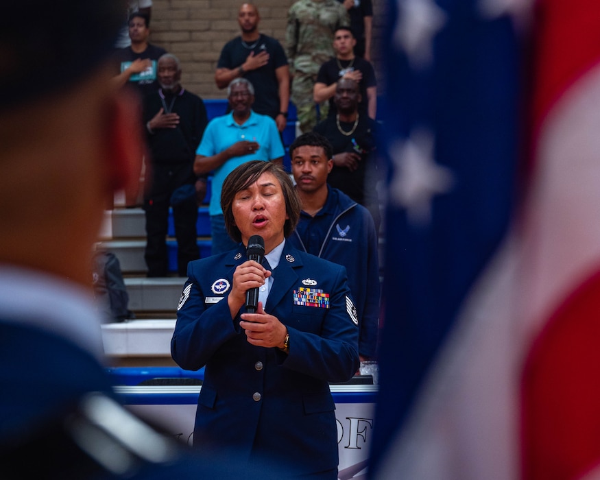 U.S. Air Force Tech Sgt. Carol Russell, 56th Maintenance Group F-35 integrated avionics journeyman, sings the national anthem, April 2, 2026, at Luke Air Force Base, Arizona.