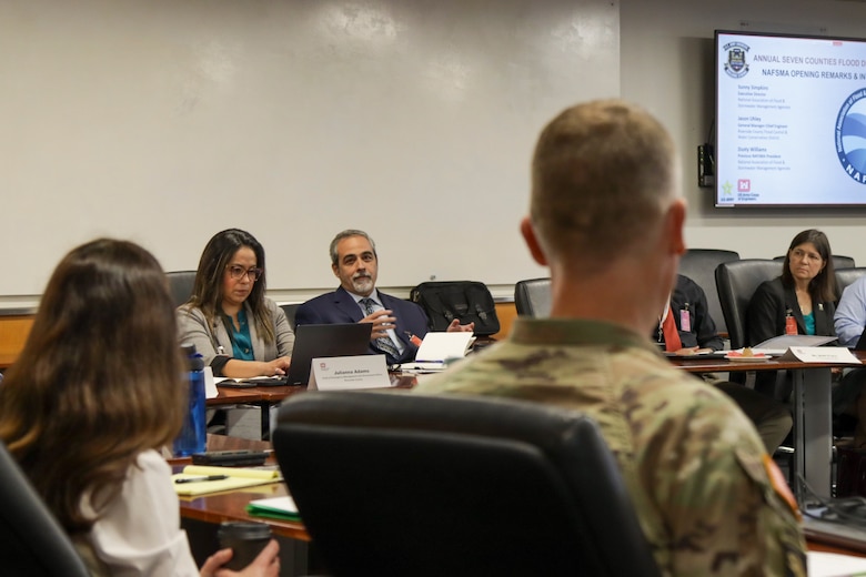 Jason Uhley, chief engineer with Riverside County Flood Control and Water Conservation District, background center, speaks to Col. Andrew Baker, USACE Los Angeles District commander, right, during the April 7 Seven Counties Flood Directors meeting at the LA District headquarters building in downtown Los Angeles.