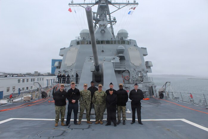 260306-N-OV429-2003 NEWPORT, R.I. (March 6, 2026) – Sailors from Navy Medicine Readiness and Training Command (NMRTC) New England, stand together following a tour onboard the future Arleigh Burke-class guided missile destroyer USS Harvey C. Barnum Jr. (DDG 124), March 6, 2026. The tour highlighted the vital role Navy Medicine plays in sustaining warfighter readiness at sea, reinforcing how medical Sailors contribute directly to mission success. NMRTC New England provides operational training to healthcare professionals through healthcare delivery to optimize both medical staff and Warfighter and readiness. (U.S. Navy photo by Hospital Corpsman Third Class Jammel Tilley)