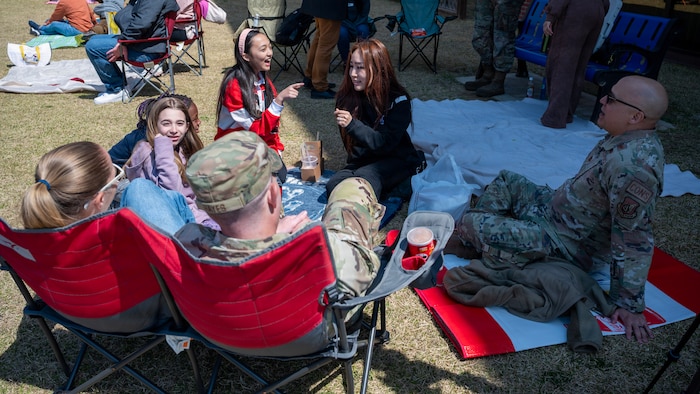 Madison Sevold, Osan Elementary School student, spends time with her family and friends during the Month of Military Child Picnic at Osan Air Base, Republic of Korea, April 8, 2026. The event offered a meaningful break from the school day and a chance to reconnect with family. (U.S. Air Force photo by Staff Sgt. Sarah Williams)