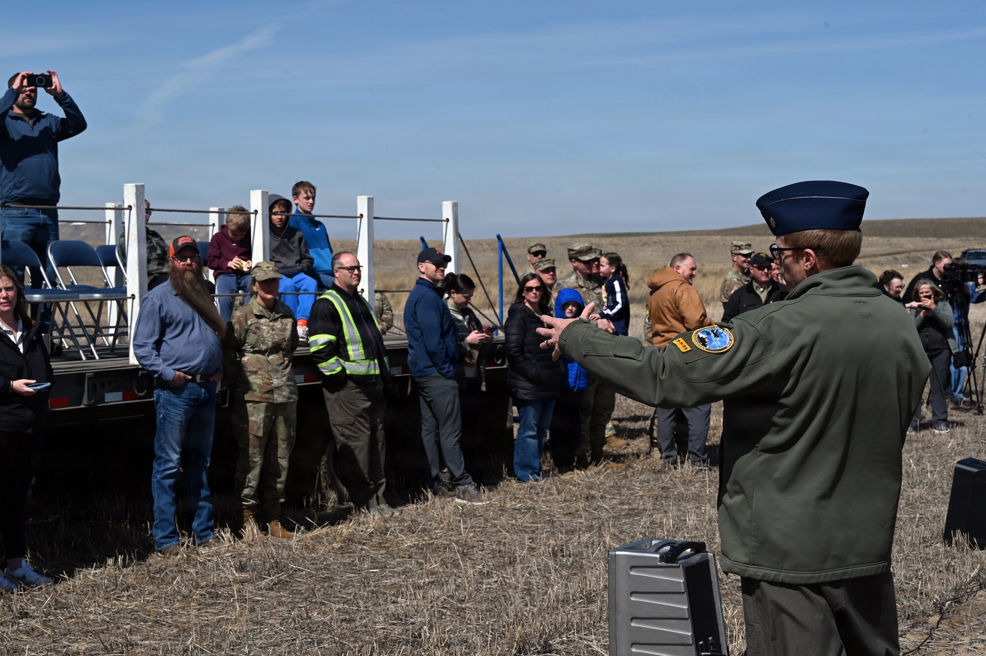 A Montana Air National Guard member briefs attendees during an aerial delivery demonstration at the Vigilante Drop Zone near Power, Montana, April 6, 2026.